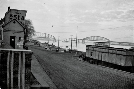 View of the Nijmegan, Holland railroad bridge in early November 1944. German frogmen were successfull in dropping the center span. The same section of span was damaged (and replaced later) during the German invasion of Holland in May of 1940.